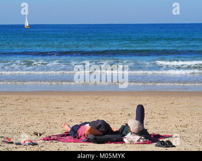 Erholung im Urlaub - Paar ist in der Sonne liegend an einem Sandstrand Stockfoto