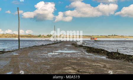 Boote in der OARE Sümpfen mit der Insel Sheppey im Hintergrund, in der Nähe von Faversham, Kent, England, Großbritannien Stockfoto