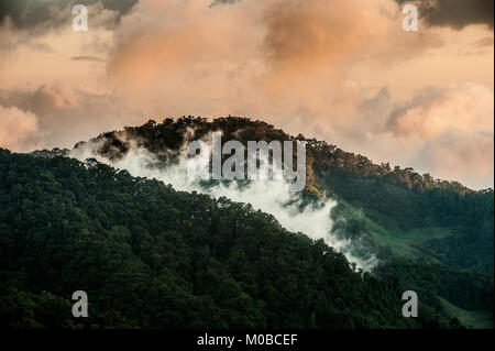 In den frühen Morgenstunden in Cloud Berge setzen Sie sich auf Tops, Erstellen einer Nebel, und werden von der Sonne hervorgehoben, ungewöhnliche rosa Farbe. Stockfoto