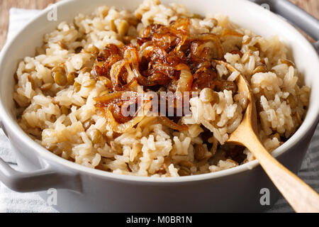 Vegetarisches Essen: Reis mit Linsen und karamellisierten Zwiebeln Makro in eine Schüssel. Horizontale Stockfoto