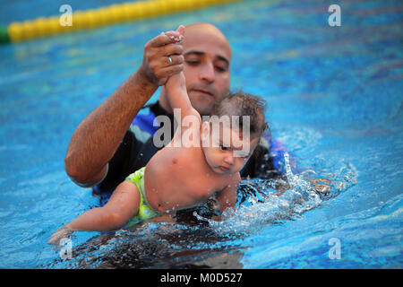 Kairo. 16 Jan, 2018. Ein Kind schwimmt mit einem Trainer in Kairo, Ägypten, Jan. 16, 2018. An einem kleinen geschlossen und Getäfelten hygienische Schwimmbad in einer Schule am Stadtrand von Kairo, ein Dutzend Eltern nahmen ihre Babys die spezielle schwimmkurse in der einzigartigen Zentrum von internationalen Babyschwimmen Trainer Mohamed Abdel-Maksoud zu besuchen. Credit: Ahmed Gomaa/Xinhua/Alamy leben Nachrichten Stockfoto