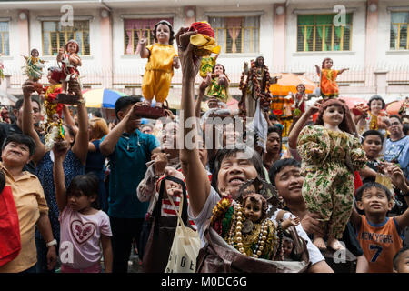 Philippinen. 21 Jan, 2018. Die katholischen Gläubigen um die Kirche von Sto gesammelt. Nino (Jesuskind) in Tondo Manila, wie sie das jährliche Festival feiern. Tausende bringen ihre eigenen Bilder und Statuen, die meisten von ihnen von Generation zu Generation weitergegeben, des Kindes Jesus als Priester die Bilder mit Weihwasser segnen. Credit: J Gerard Seguia/ZUMA Draht/Alamy leben Nachrichten Stockfoto