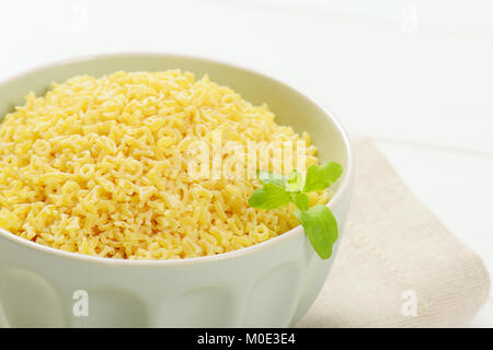 Schüssel ungekochten Alphabet Nudeln auf beige Unterlage - Nahaufnahme Stockfoto