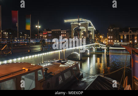 Amsterdam, Niederlande, 16. Dezember 2017: Die Magere Brücke über den Fluss Amstel mit im Hintergrund die charakteristischen Kanäle Gebäude in der o Stockfoto