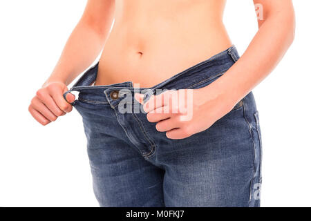 Frau zeigt, dass Sie Gewicht verloren hat. Big Jeans. Stockfoto