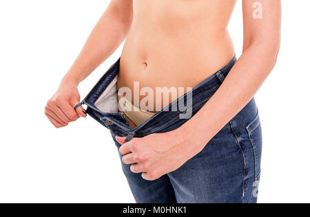 Frau zeigt, dass Sie Gewicht verloren hat. Big Jeans. Stockfoto