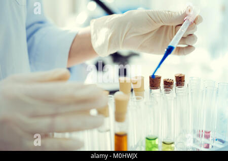 Lab Arbeiter mit Pipette, die während der Arbeit mit Flüssigkeiten Stockfoto