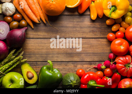 Rahmen der verschiedenen Arten von Obst und Gemüse auf einem Holztisch mit negativen Raum zu Logo oder Text platzieren. Stockfoto