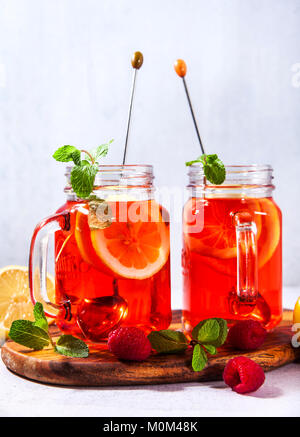 Eistee mit Orange und Himbeere in zwei Gläser und Minze Stockfoto