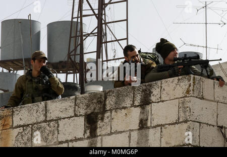 Hebron, West Bank, 23 Jan, 2018. Israelische Sicherheitskräfte nehmen Stellung bei Zusammenstößen mit palästinensischen Demonstranten in der Stadt Hebron, wie Protesten nach US Vizepräsidenten Bekräftigung der Dezember US Präsident Donald Trump 6 Erklärung von Jerusalem als Israels Hauptstadt ausbrach. Mike Pence versprach, die Botschaft zu den umstrittenen Stadt Jerusalem zu verschieben bis Ende 2019, während die Palästinenser mit einem Generalstreik und Proteste nach Kündigung seiner inbrünstig pro-Israel Rede am Tag zuvor als ''Messianic Cred reagiert. Stockfoto