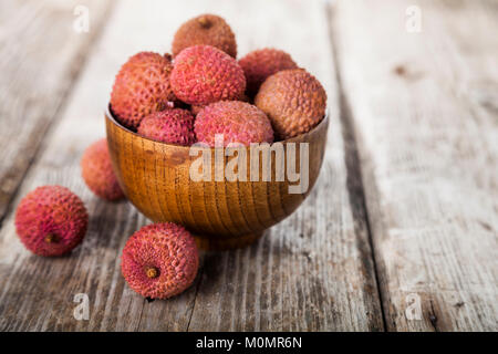 Lychee in eine hölzerne Schüssel auf dem Tisch. Köstliche tropische Früchte. Stockfoto