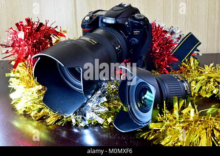 Nikon DSLR D80 und Akku und Linsen auf dem Display und Weihnachtsschmuck sowie Stockfoto