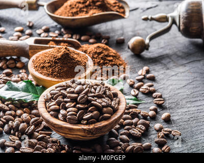 Geröstete Kaffeebohnen und gemahlener Kaffee auf Holztisch. Stockfoto