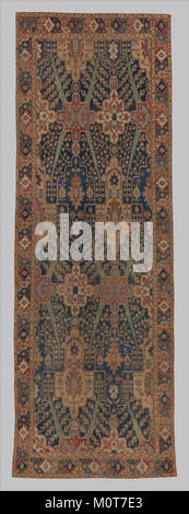 Dieser Teppich, der in der MET ausgestellt wird, ist mit einem Baum- und Kartuschendesign versehen, das die komplizierte Handwerkskunst widerspiegelt. Es ist ein Beispiel für den künstlerischen Stil und die kulturellen Muster seiner Zeit. Stockfoto