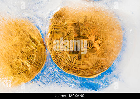 Blick auf die goldenen Münzen von Bitcoin cryptocurrency in Eis eingefroren Stockfoto