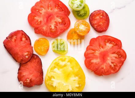 Lycopersicon esculentum. Scheiben von bunten Erbe Tomaten. Stockfoto