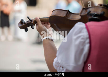 Ansicht der Rückseite eine polnische Frau Spielen der Violine mit traditionellen Kostüm Stockfoto