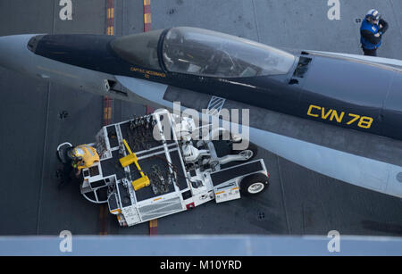 Atlantik (Jan. 24, 2018) - der Luftfahrt Bootsmann Mate (Handling) 3. Klasse Renardo Blackford (links), von Bronx, New York, zugeordnet zu den USS Gerald R. Ford's (CVN 78) Luft Abteilung, bewegt sich eine F/A-18 Hornet Trainer auf ein Flugzeug Aufzug. Ford ist im Gange, die Durchführung von Test und Bewertung. (U.S. Marine Foto von Mass Communication Specialist 3. Klasse Katze Campbell) Stockfoto
