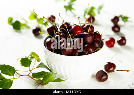 Frische Kirschen in Schüssel weiß Stockfoto
