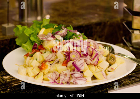 Salat aus dem gekochten Kartoffeln, Thunfisch, Roten Zwiebeln und Salatblätter Stockfoto