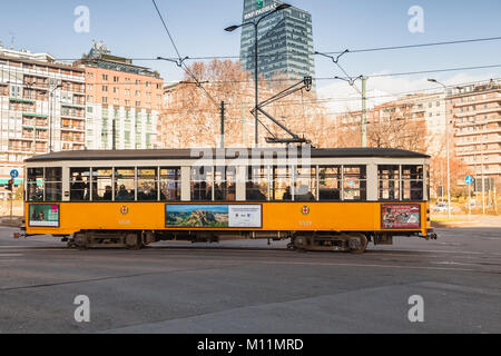 Mailand, Italien - Januar 19, 2018: Gelbe Tram mit normalen Passagiere geht auf die Straße, Milano, Seitenansicht Stockfoto