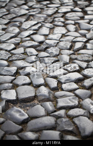 Pflastersteine Hintergrund der alten Kopfsteinpflaster close-up. Stockfoto