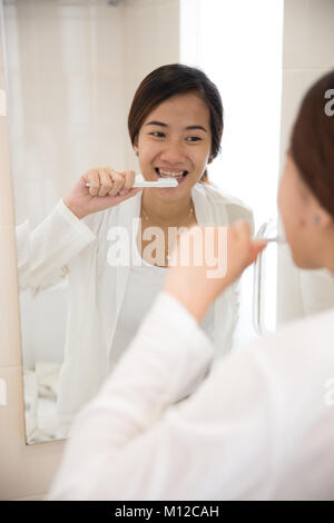 Das Portrait einer schönen asiatischen Frau ihre Zähne putzen glücklich Stockfoto