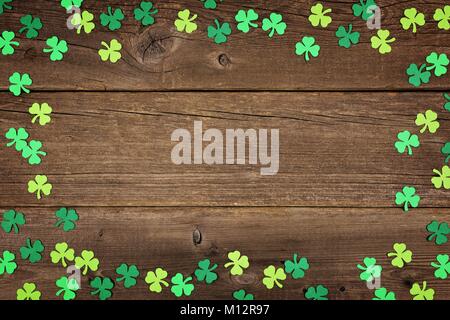 St Patricks Day frame Papier shamrocks über ein altes rustikales Holz Hintergrund Stockfoto