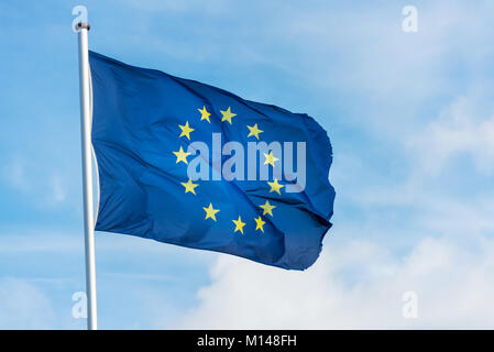 Nahaufnahme des einheitlichen europäischen Flagge mit zwölf gelben Sternen winken im Wind vor blauem Himmel Stockfoto