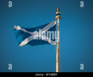 Schottische Flagge weht im Wind auf einem Mast Stockfoto