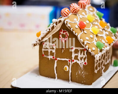 Ein Lebkuchen Haus von Sahne und Gummies auf dem Dach eingerichtet Stockfoto