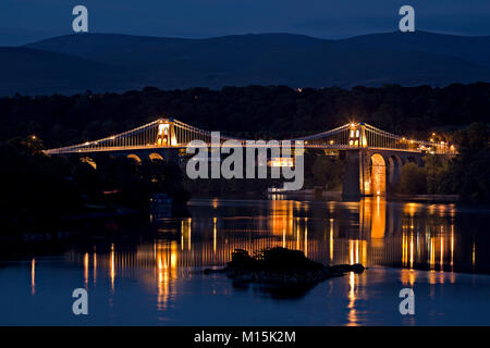 Thomas Telford Hängebrücke über die Menai Straits bei Nacht, die in den Gewässern der Menai Straits, Anglesey Stockfoto