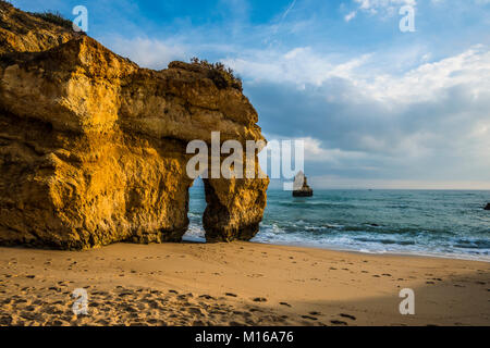 Felsige Küste mit Strand und roten Felsen, Praia do Camilo, Lagos, Algarve, Portugal Stockfoto