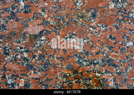 Rot Grau Granit Hintergrund und Tapeten. Flecken aus rotem Granit in einem grauen Masse von Naturstein. Stockfoto