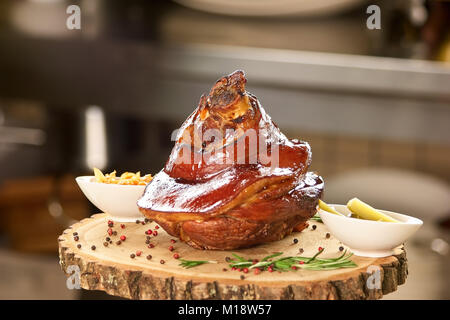 Schweinebraten mit Beilagen in weißen Töpfe. Stockfoto