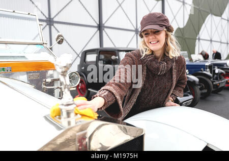 Katie Forrest, 32, aus Guildford, reinigt Ihr 1912 Roll-Royce Silver Ghost, bekannt als das "Taj Mahal" und ursprünglich von der Maharadscha von Nabha besaß, während der jährlichen Fahrprüfungen für die Vintage Sports-Car Club, um Kurse in das Brooklands Museum, Weybridge, Surrey. Stockfoto