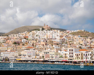 SYROS, Griechenland - 10 April, 2016: Blick von Syros Hafen mit schönen Gebäuden und Häusern an einem sonnigen Tag mit Wolken Stockfoto