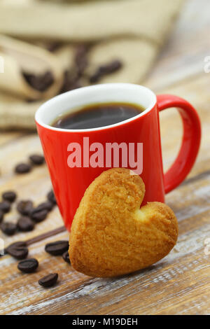 Keks in Form von Herzen lehnte sich gegen Coffee Mug Stockfoto