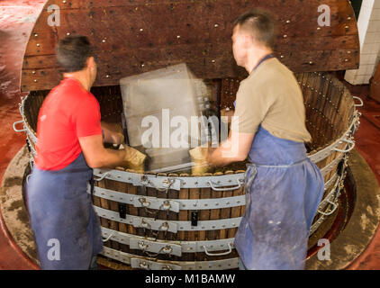 Épernay, Frankreich - 10. September 2017: Alte hölzerne Wein pressen (Pressoir) und Männer arbeiten mit Kisten der Trauben im Champagne in Épernay, Frankreich Stockfoto