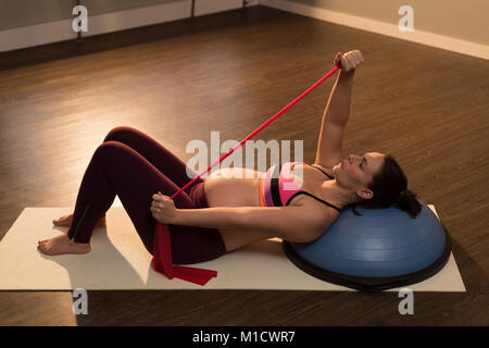 Schwangere Frau Ausübung im Wohnzimmer Stockfoto