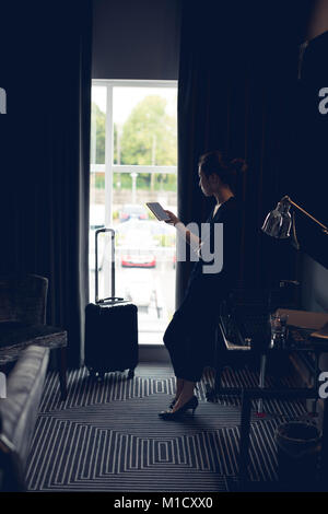 Frau digital Tablet im Hotel Zimmer Stockfoto