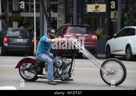 Ein Motorradfahrer sitzt auf seinem individuellen hog Motorrad auf der Straße in Fredericksburg, Texas Stockfoto