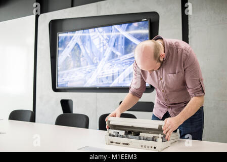 Ein Mitglied des Personals zeigt Macintosh Portable, Erscheinungsdatum September 1989, auf dem ukrainischen MacPaw Apple's Museum in Kiew, Ukraine am 26. Januar 2017. Die ukrainischen Entwickler MacPaw hat Apple Hardware Museum im Büro des Unternehmens in Kiew eröffnet. Die Sammlung verfügt über mehr als 70 ursprünglichen Macintosh Modellen von 1981 bis 2017 datiert. Stockfoto