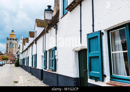 Fassade des alten historischen Gebäude mit der Kirche von Jerusalem (Jeruzalemkerk) im Hintergrund in der mittelalterlichen Stadt Brügge, Belgien. Stockfoto