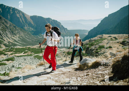 Mann und Frau Nordic Walking in der Hohen Tatra auf einem hellen Tag. Stockfoto