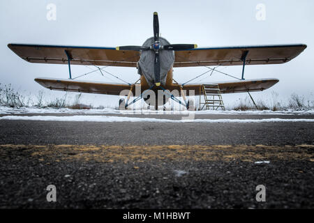 Ein Bild vom Flugplatz im Winter. Die alten Doppeldecker steht auf der Start- und Landebahn und warten auf besseres Wetter, so kann sie wieder fliegen. Stockfoto