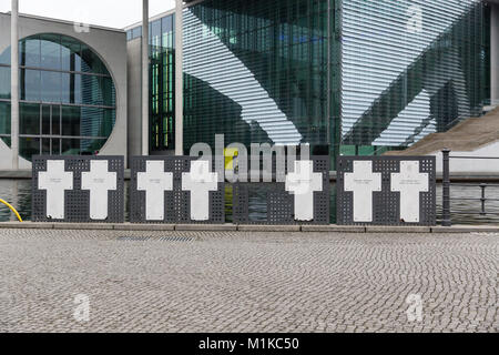 Memorial Kreuze zum Gedenken an die Opfer der Berliner Mauer an der Spree mit neben dem modernen Gebäuden der deutschen Regierung in den Hintergrund. Stockfoto