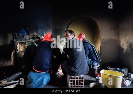 Kelebija, Serbien. 25 Jan, 2018. In einem verlassenen Bauernhof in der Nähe der ungarischen Grenze Migranten aus Pakistan warm selbst um ein Feuer. Ungarn und Kroatien wurden die Grenzkontrollen in den letzten Jahren, die in vielen Flüchtlingen und Migranten immer in Serbien klemmt geführt hat. Credit: Edward Crawford/SOPA/ZUMA Draht/Alamy leben Nachrichten Stockfoto