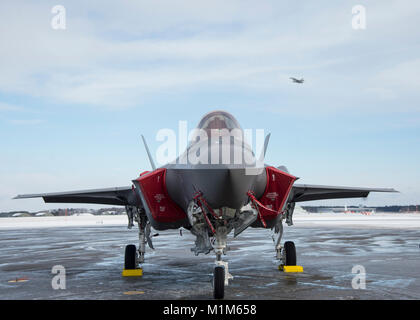 Die ersten operativen Japan Air Verteidigung-kraft F-35 eine sitzt auf der Flightline während einer F-16 Fighting Falcon aus während die F-35 eine Begrüßungszeremonie bei Misawa Air Base, Japan, Jan. 25, 2018. In den kommenden japanischen Geschäftsjahr, neun weitere Flugzeuge werden diese eine der ersten fünften Generation fighter Squadron zu incept als Teil 3 des JASDF Air Wing beitreten. (U.S. Air Force Foto: Staff Sgt. Deana Heitzman) Stockfoto