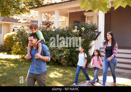 Vater Sohn Fahrt auf Schultern, als Familie Haus verlassen Stockfoto